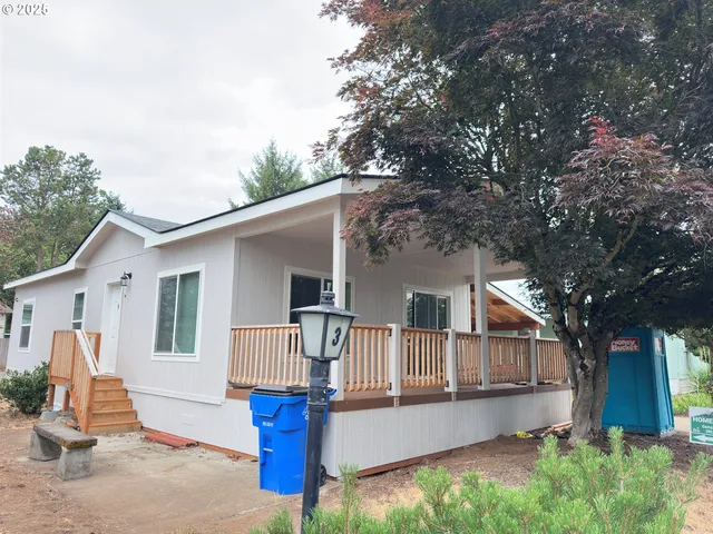 a front view of a house with a patio and barbeque oven