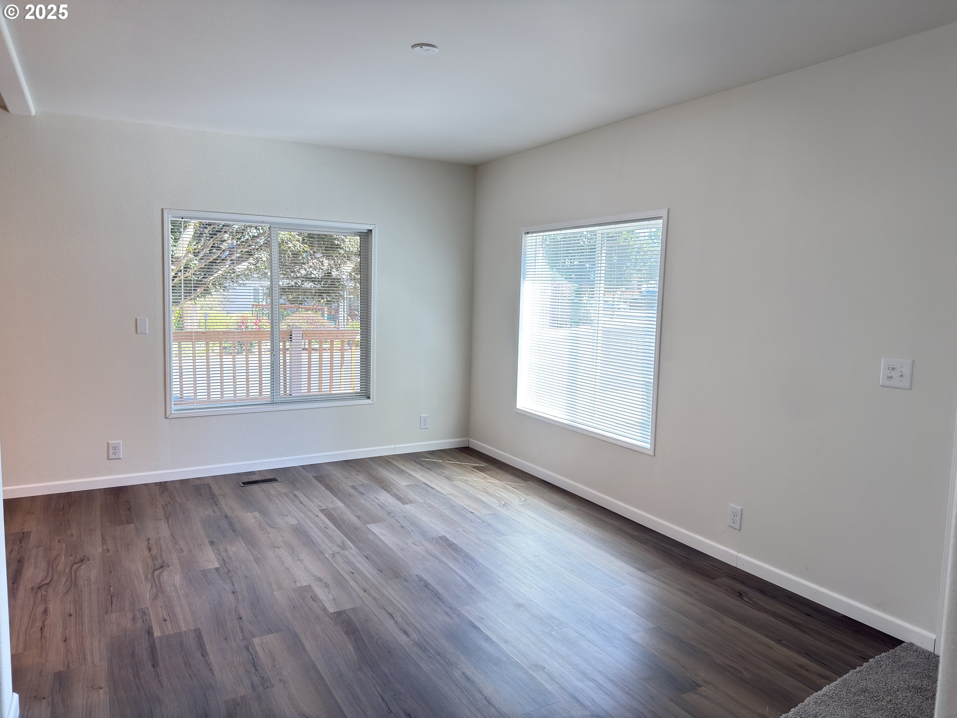 11316 Northeast 28th Street, Unit 3 Vancouver, WA 98682 - Photo 7 of 18 an empty room with wooden floor and windows