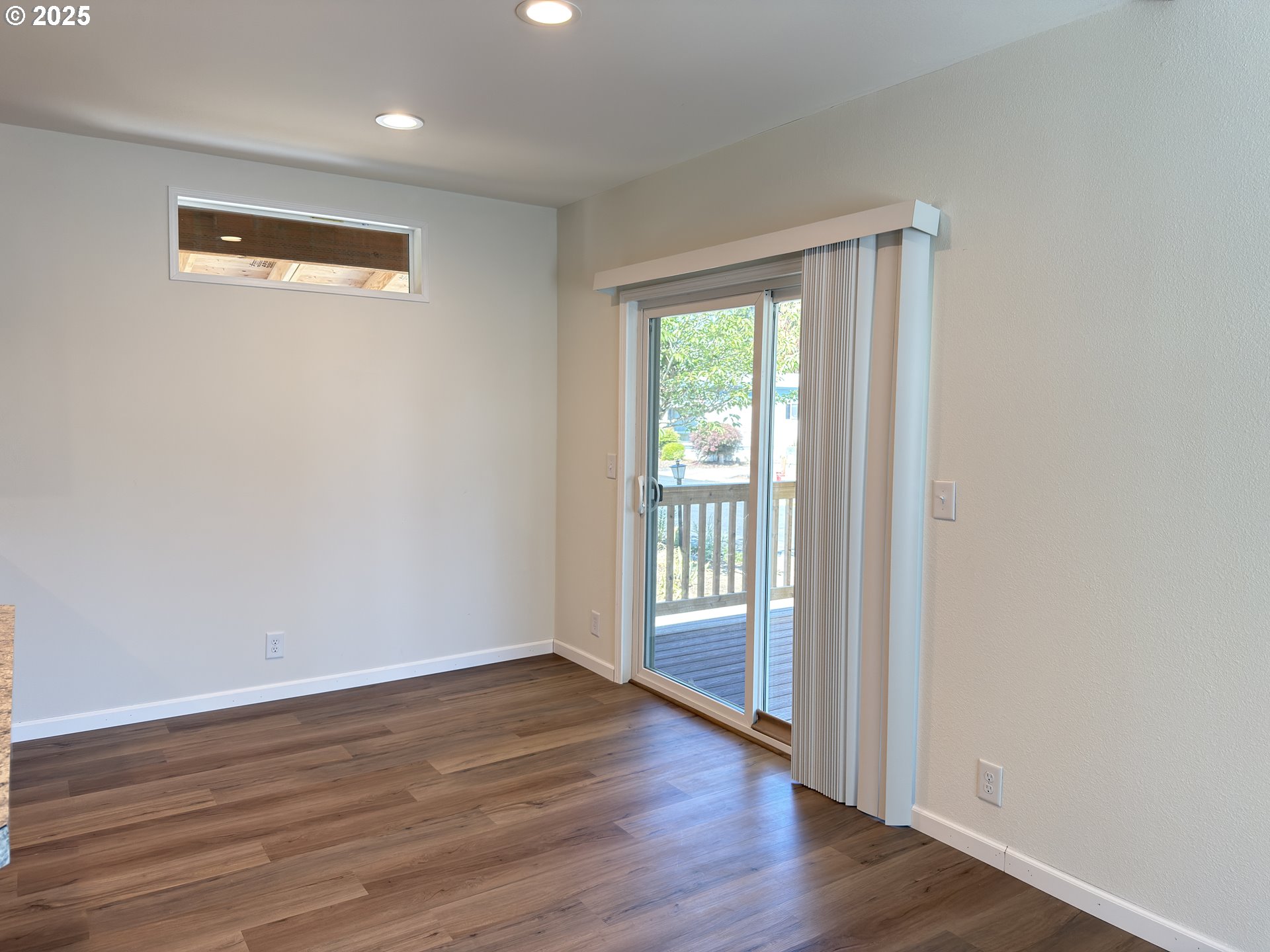11316 Northeast 28th Street, Unit 3 Vancouver, WA 98682 - Photo 8 of 18 a view of an empty room with wooden floor and a window