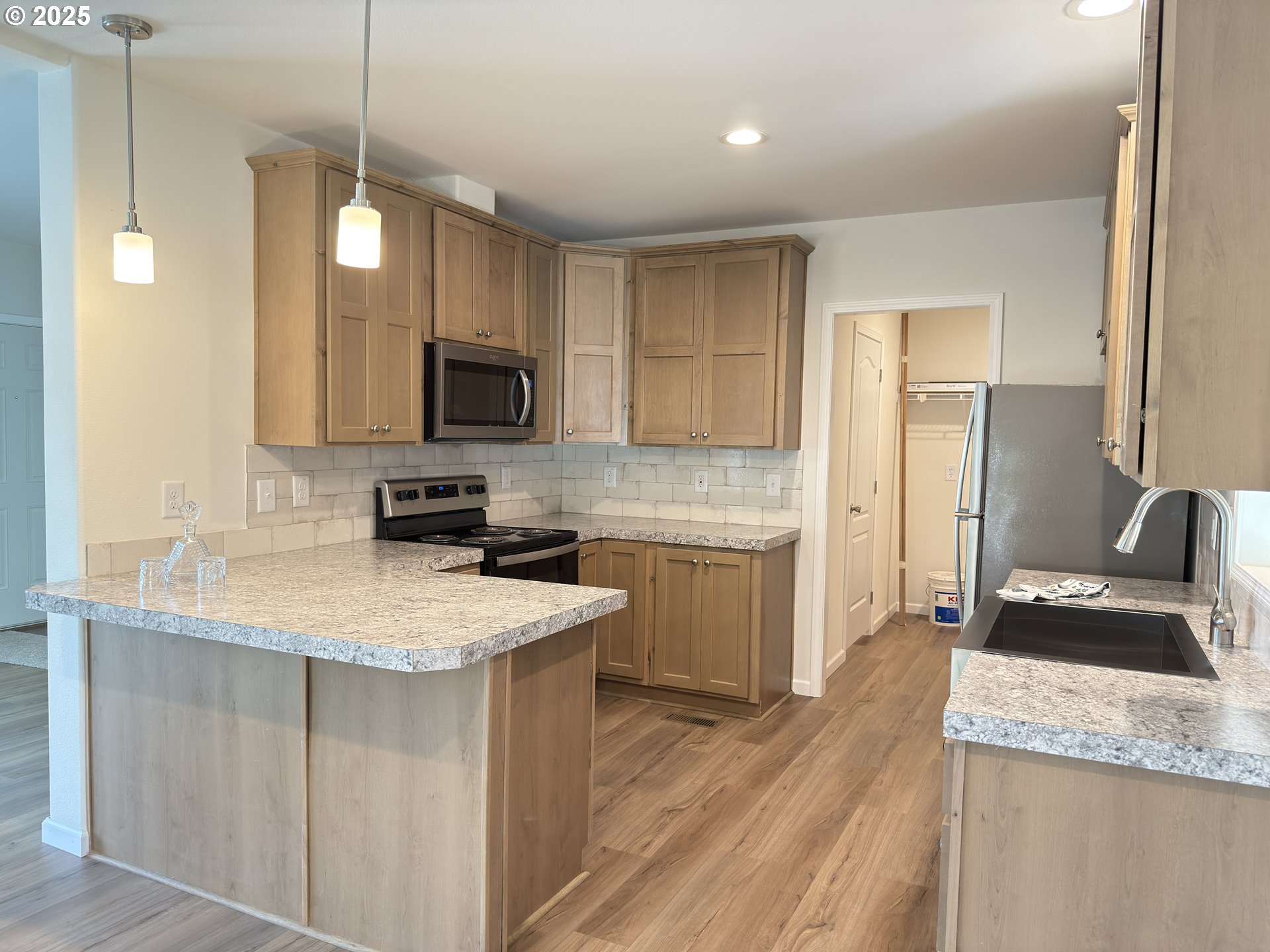 11316 Northeast 28th Street, Unit 3 Vancouver, WA 98682 - Photo 10 of 18 a kitchen with a sink stove and refrigerator