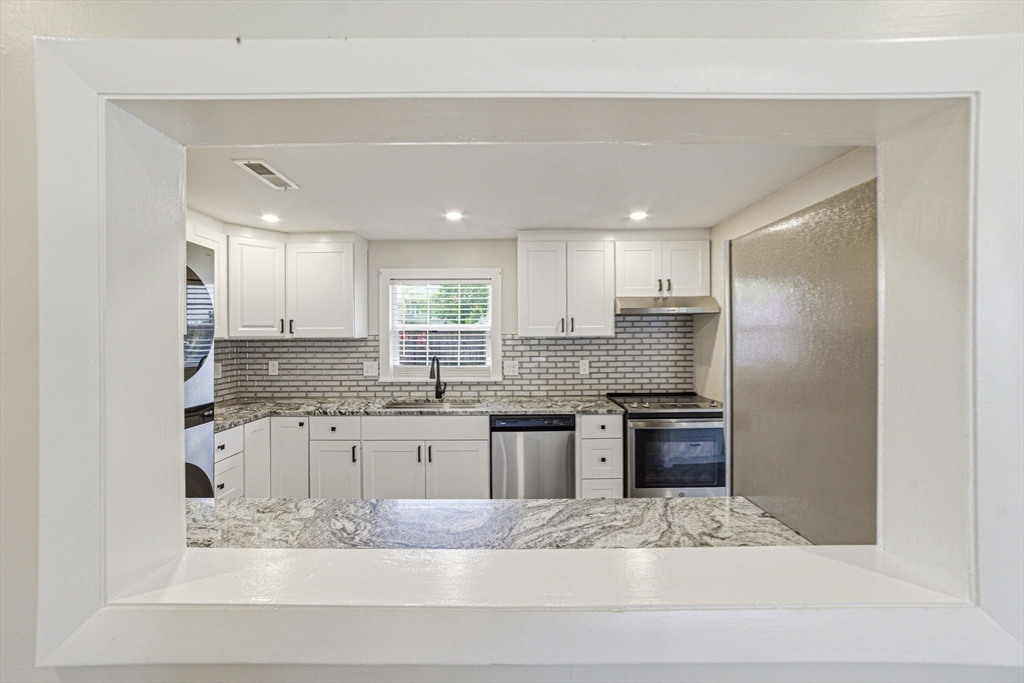 157 Errol Road Brockton, MA 02302 - Photo 18 of 34 a kitchen with stainless steel appliances granite countertop a sink and cabinets