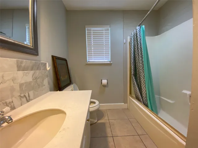a bathroom with a bathtub and shower