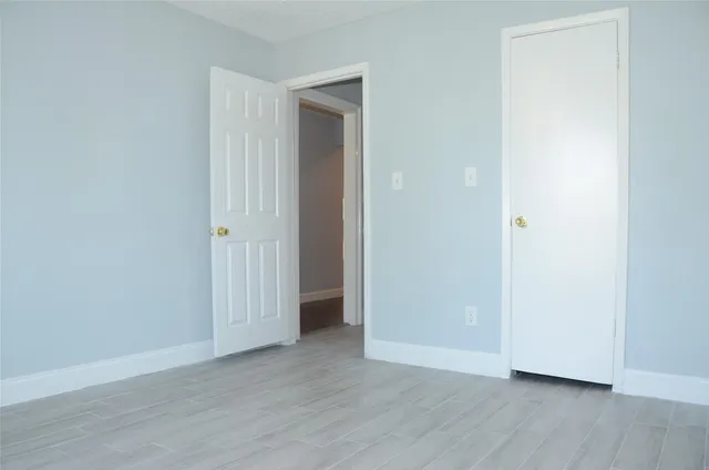 a view of an empty room and wooden floor