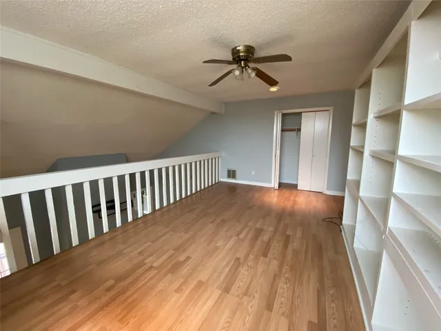 a view of a room with wooden floor and staircase
