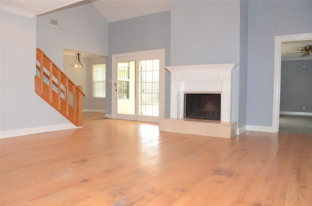 a view of an empty room with glass door and a window