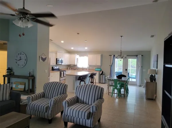 a living room with furniture and a dining table