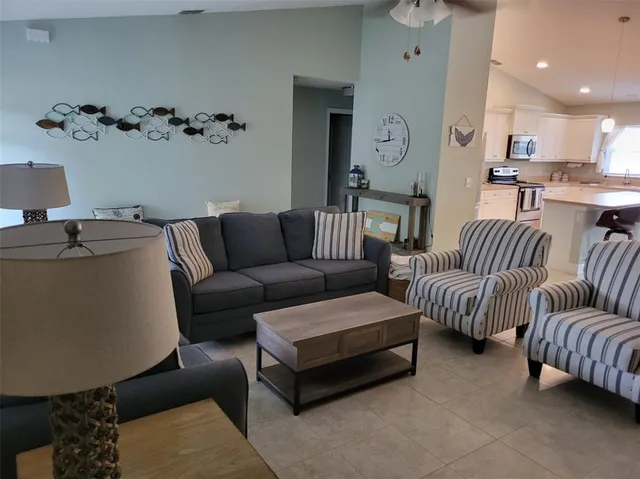 a bedroom with a bed and a flat tv screen on dresser