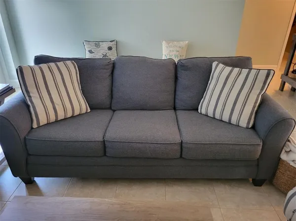a bedroom with a bed and a flat tv screen on dresser