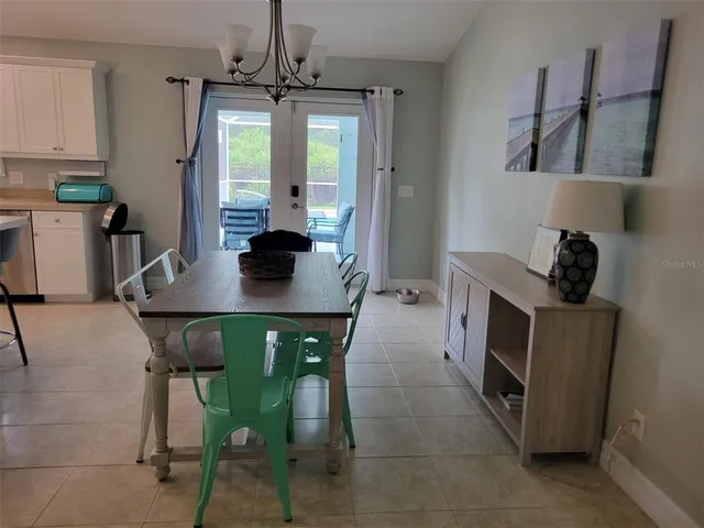 a living room with a bed and a wooden floor