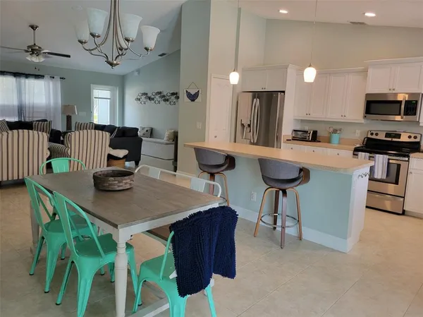 a view of a hallway and a livingroom with a mirror