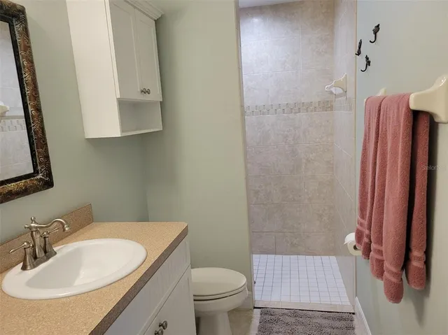 a view of a tennis ground with a swimming pool