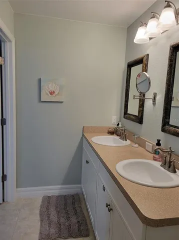 a view of a house with a yard and potted plants