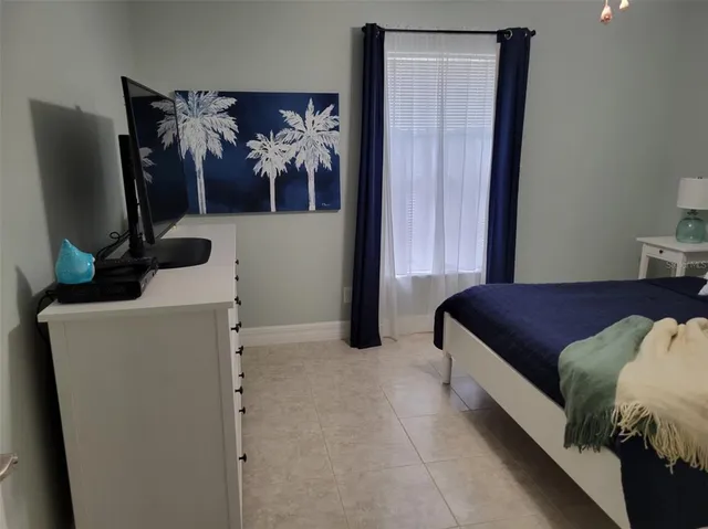 a view of a backyard with a garden and tall trees