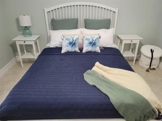 a view of a house with a big yard and a large tree