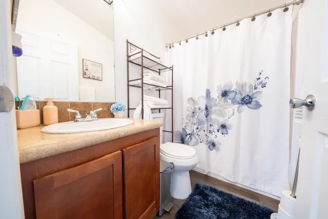 a bathroom with a sink toilet and shower