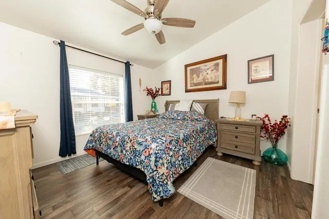 a bed sitting in a bedroom next to a window