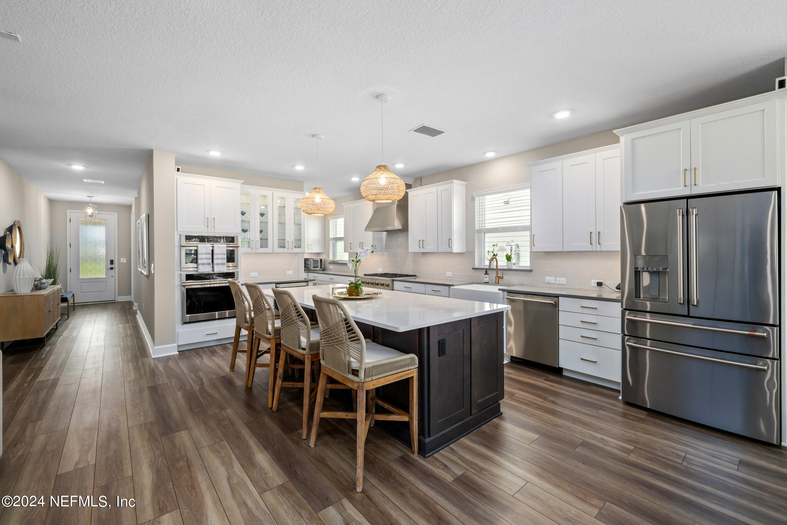 98 Sumter Pl Street St. Augustine, FL 32092 - Photo 19 of 84 a kitchen with stainless steel appliances a dining table chairs stove and refrigerator