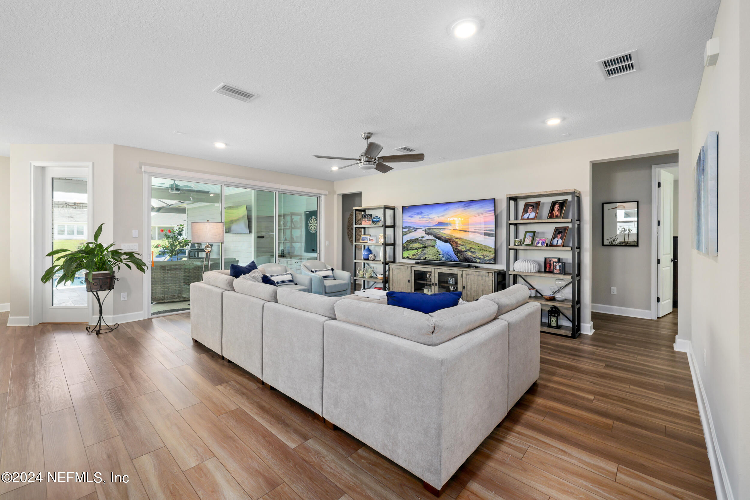 98 Sumter Pl Street St. Augustine, FL 32092 - Photo 27 of 84 a living room with furniture a large window and wooden floor