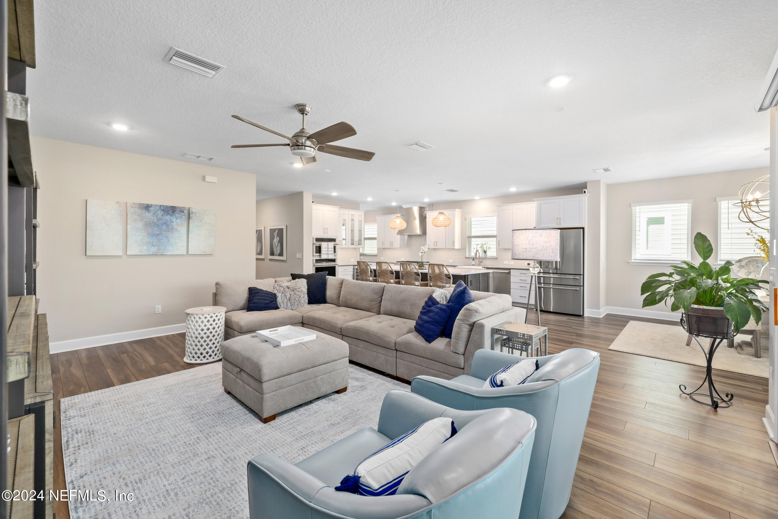 98 Sumter Pl Street St. Augustine, FL 32092 - Photo 31 of 84 a living room with furniture and a large window with wooden floor