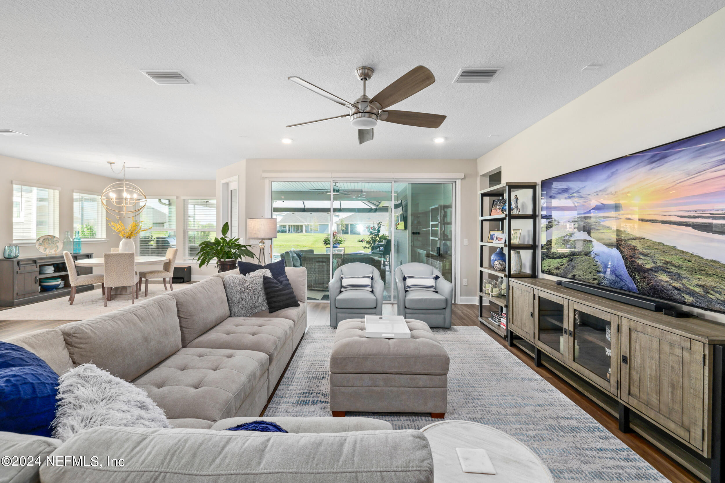 98 Sumter Pl Street St. Augustine, FL 32092 - Photo 33 of 84 a living room with furniture a flat screen tv and a large window