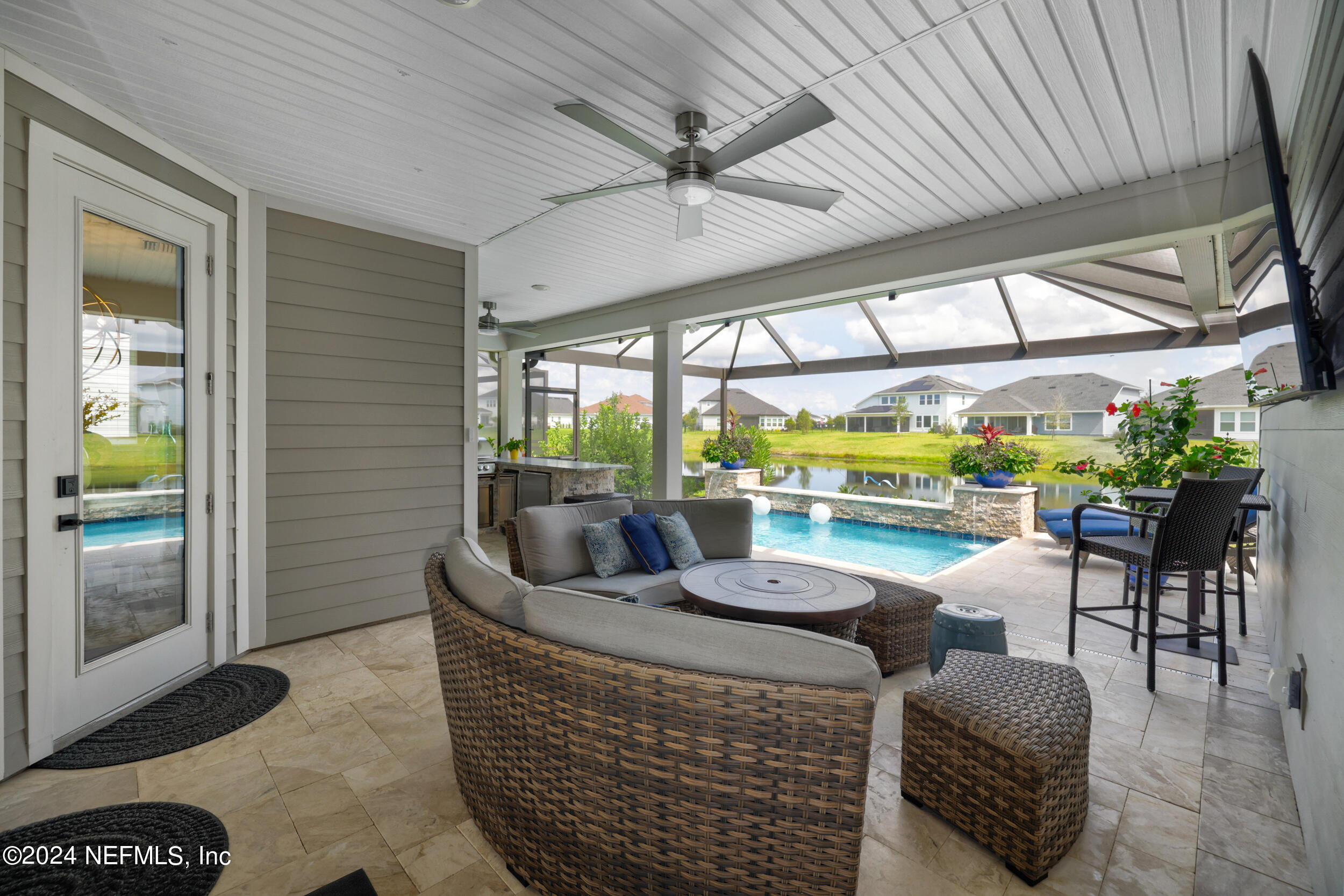 98 Sumter Pl Street St. Augustine, FL 32092 - Photo 37 of 84 a living room with patio furniture and a floor to ceiling window