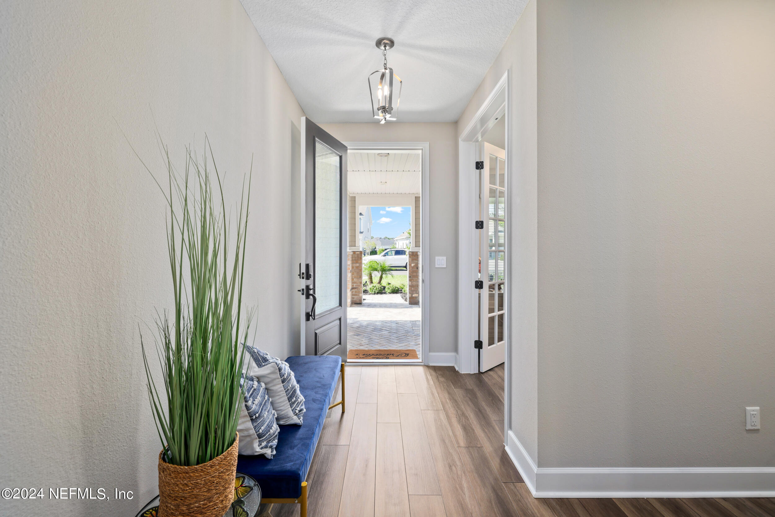 98 Sumter Pl Street St. Augustine, FL 32092 - Photo 4 of 84 a view of a hallway with a chandelier and glass door