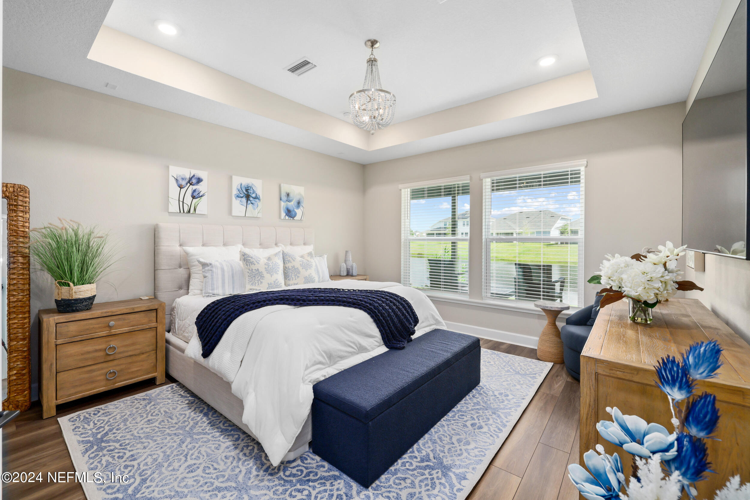 98 Sumter Pl Street St. Augustine, FL 32092 - Photo 56 of 84 a bedroom with a bed a couch and a chandelier