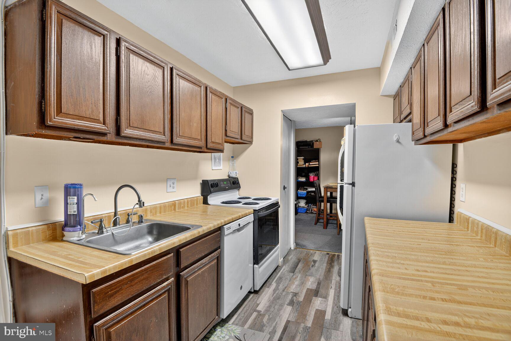 8007 Mandan Road, Unit 203 Greenbelt, MD 20770 - Photo 9 of 25 a kitchen with stainless steel appliances granite countertop a sink and cabinets