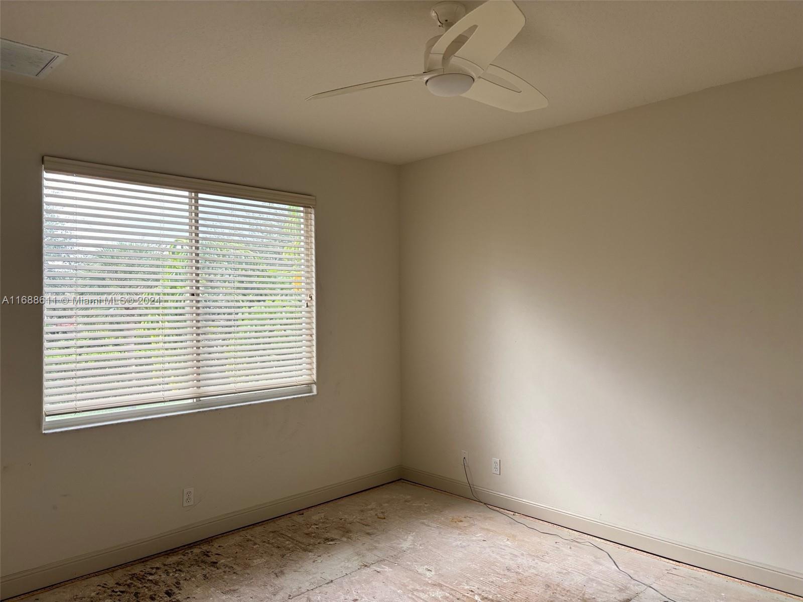 7091 Mallorca Crescent Boca Raton, FL 33433 - Photo 11 of 15 an empty room with a window