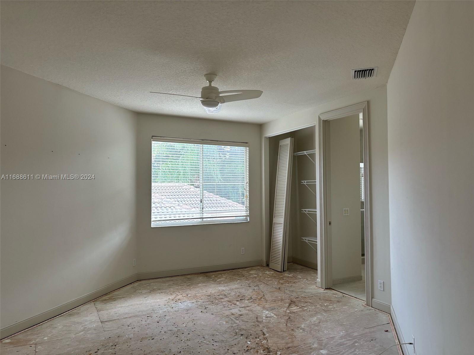 7091 Mallorca Crescent Boca Raton, FL 33433 - Photo 14 of 15 an empty room with windows and closet
