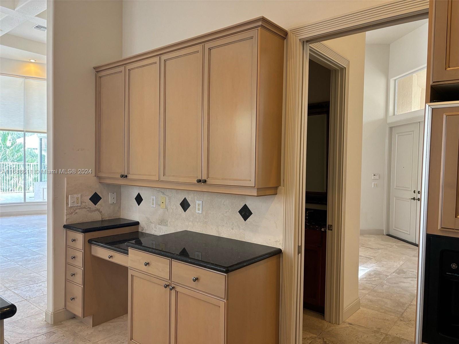 7091 Mallorca Crescent Boca Raton, FL 33433 - Photo 2 of 15 a kitchen with granite countertop a sink and a stove top oven