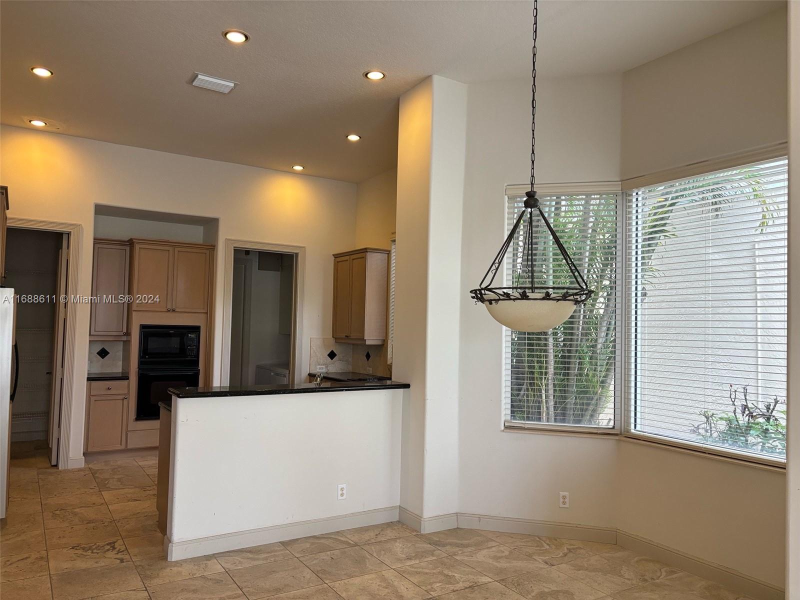 7091 Mallorca Crescent Boca Raton, FL 33433 - Photo 4 of 15 a view of a kitchen with a sink and a window