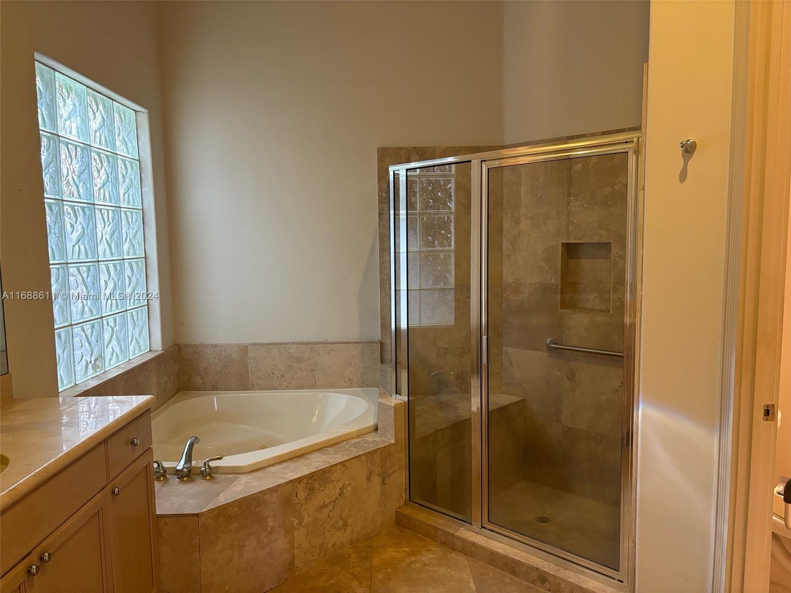 7091 Mallorca Crescent Boca Raton, FL 33433 - Photo 8 of 15 a bathroom with a tub and shower
