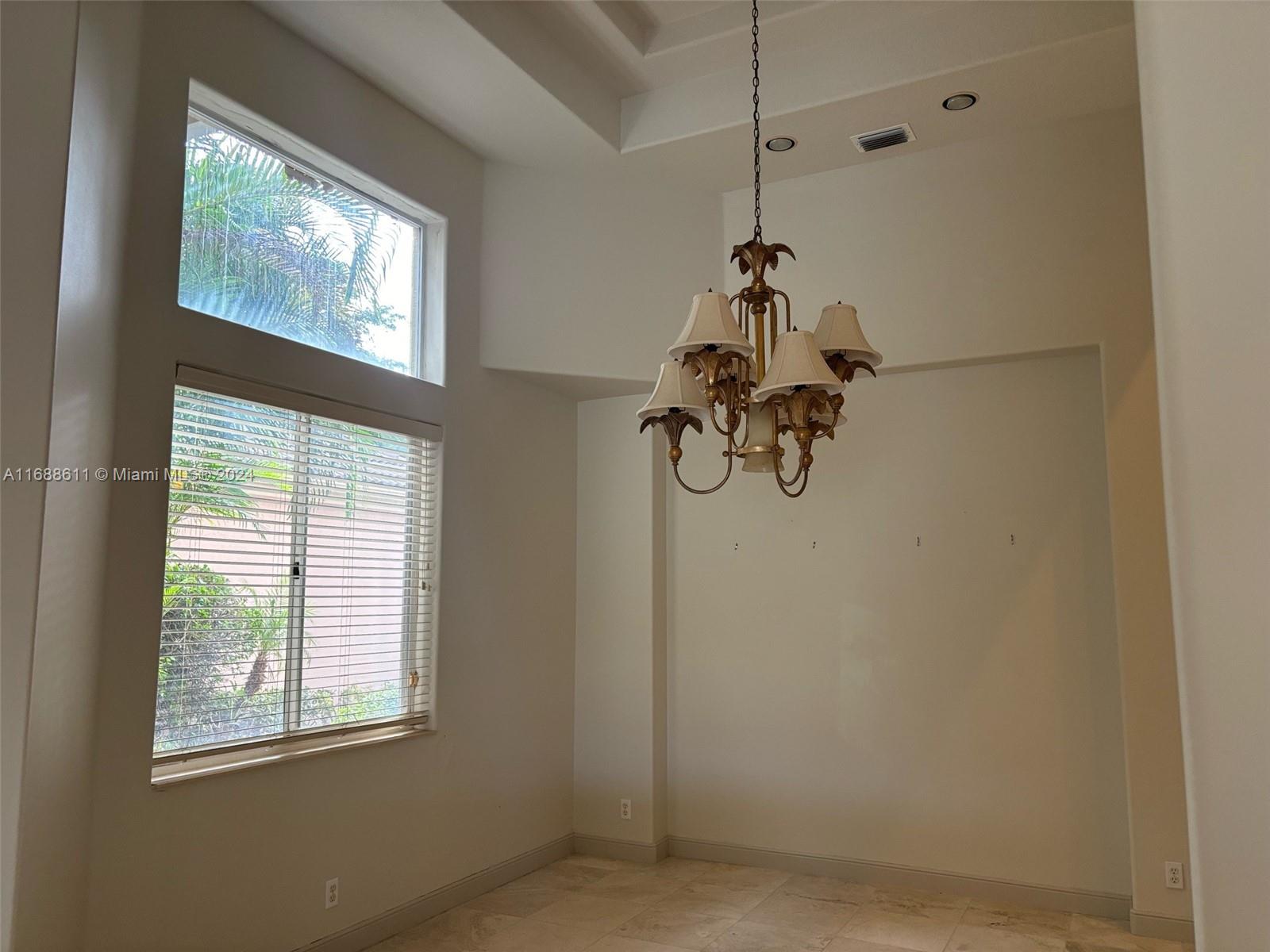 7091 Mallorca Crescent Boca Raton, FL 33433 - Photo 9 of 15 a room with a window and a glass door