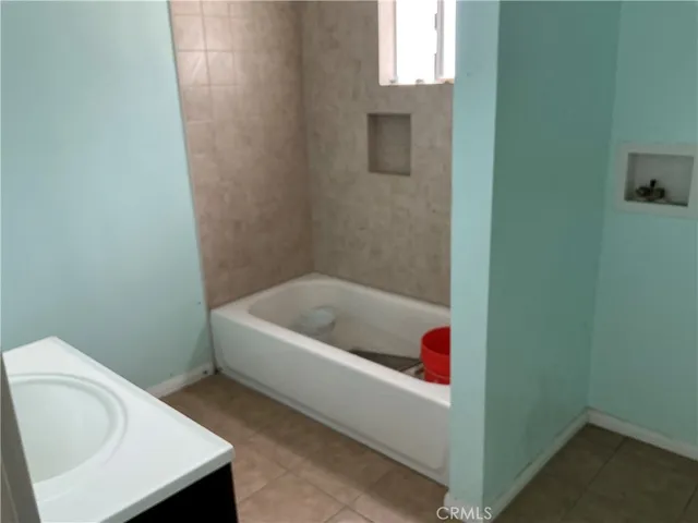 a kitchen with a sink a stove and cabinets