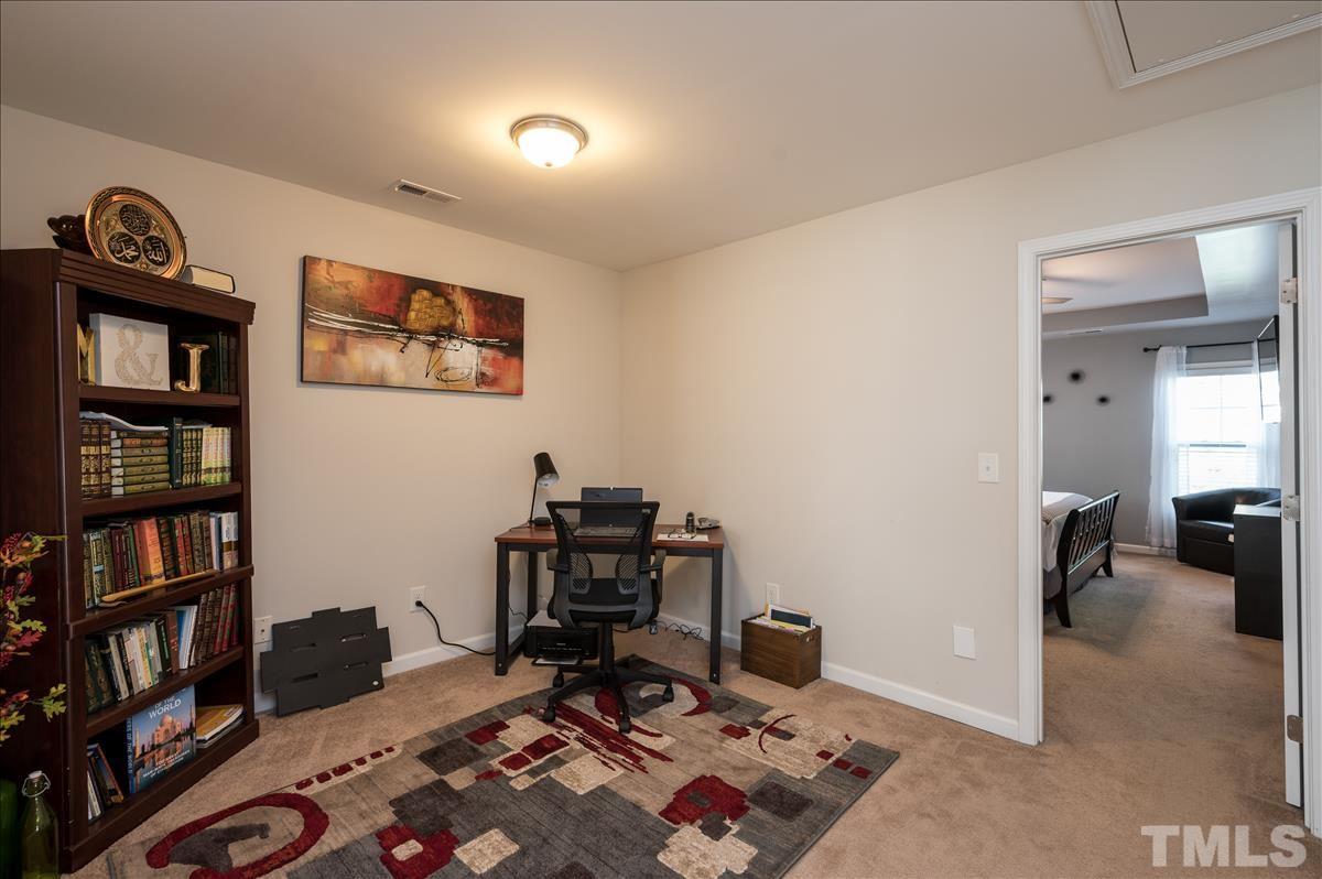 4625 Pat Reed Road Raleigh, NC 27616 - Photo 14 of 28 a view of a workspace with furniture and toys