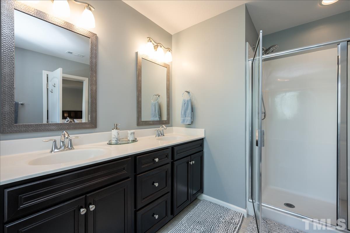 4625 Pat Reed Road Raleigh, NC 27616 - Photo 17 of 28 a bathroom with a double vanity sink mirror and shower