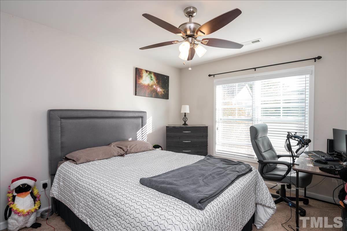 4625 Pat Reed Road Raleigh, NC 27616 - Photo 21 of 28 a bedroom with a bed and a large window