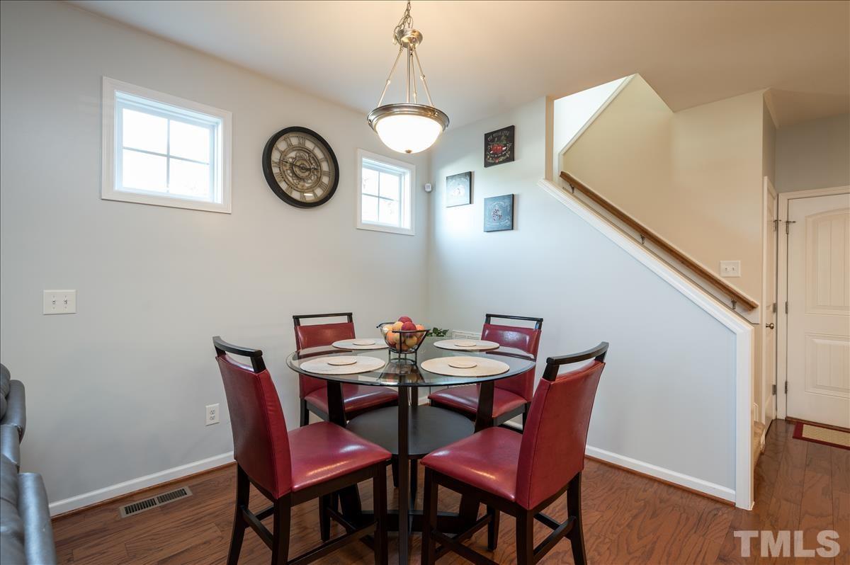 4625 Pat Reed Road Raleigh, NC 27616 - Photo 10 of 28 a view of a dining room with furniture and a clock