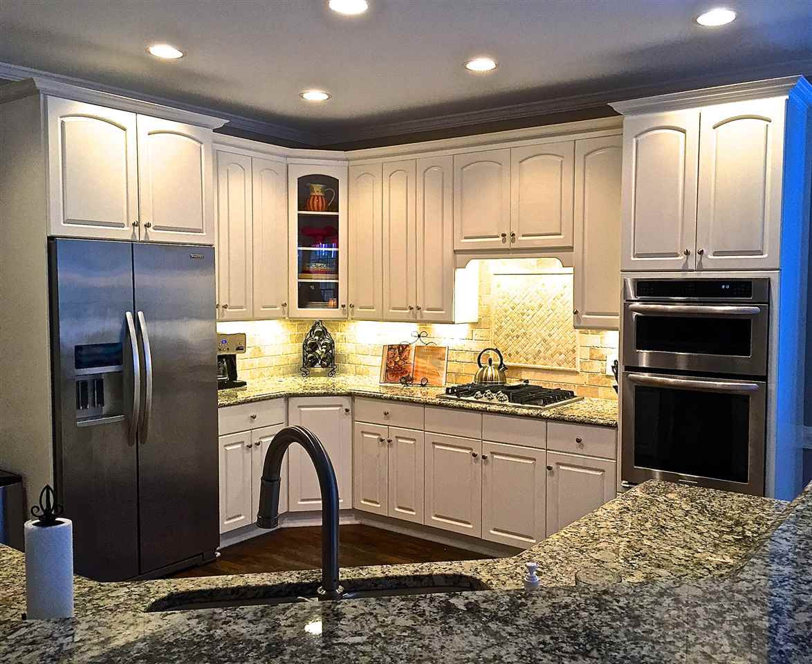 5805 Sand Pebble Place Raleigh, NC 27613 - Photo 3 of 17 Updated kitchen with granite counter tops, stainless steel appliances, back splash, and hardwood floors Kitchen