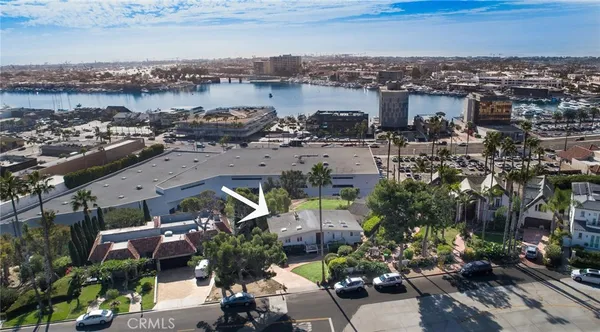 an aerial view of a building with outdoor space and lake view