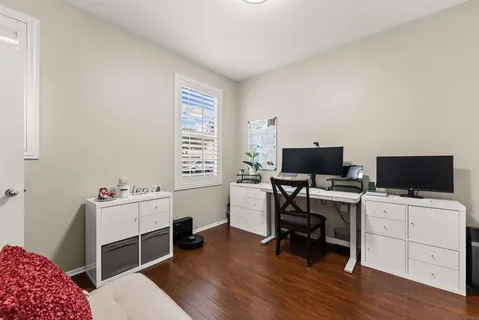 a view of a workspace with furniture and a window