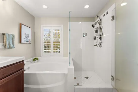 a white bath tub sitting next to a white sink