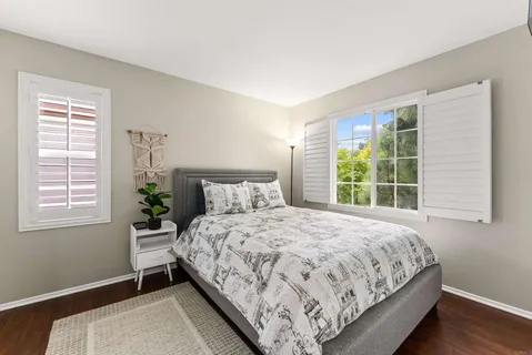 a bedroom with a bed lamp and window