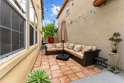 a balcony with furniture and a potted plant