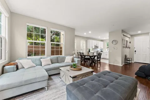 a living room with furniture and wooden floor