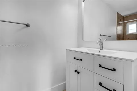 a white toilet sitting next to a shower