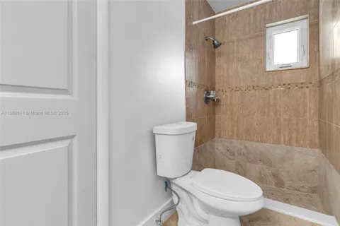 a bedroom with a balcony a bed and a potted plant