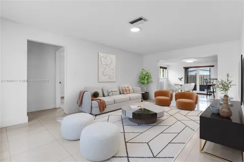 a living room with furniture rug and lamp