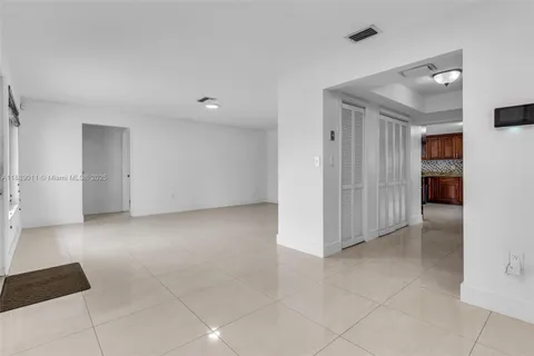 an empty room with windows and entrance